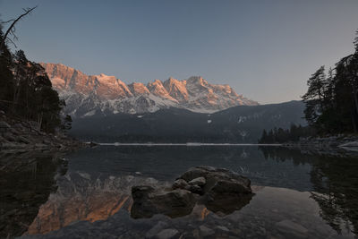 Scenic view of lake and mountains against clear sky