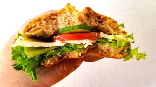 Close-up of hand holding burger