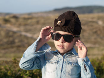 Portrait of girl wearing sunglasses and knit hat