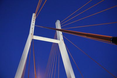 Low angle view of modern bridge against blue sky