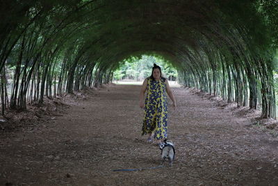 Woman with dog walking at park