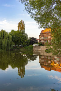 Reflection of trees and buildings on lake