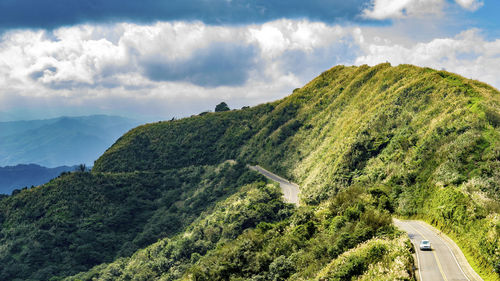 Panoramic view of green landscape against sky