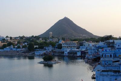 Boats in river with town in background