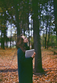 Woman standing in a forest