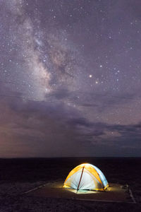 Illuminated tent against sky at night