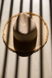 High angle view of hat hanging on wood