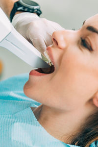 Cropped image of dentist examining patient teeth