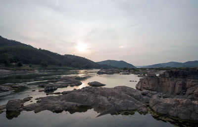 Scenic view of lake against sky during sunset