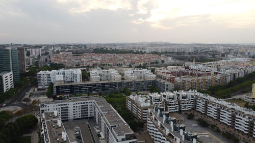 High angle shot of townscape against sky at sunset