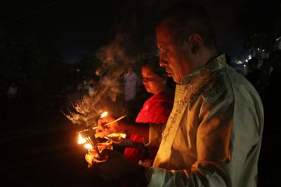 Portrait of man holding oil lamp at rakher upobash barodi lokhnath brahmachari ashram 