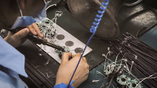 Close-up of manual worker working in factory