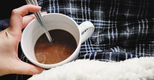 Midsection of person holding coffee cup