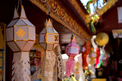 Close-up of lanterns hanging on ceiling of building