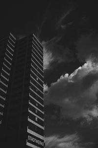 Low angle view of modern building against cloudy sky