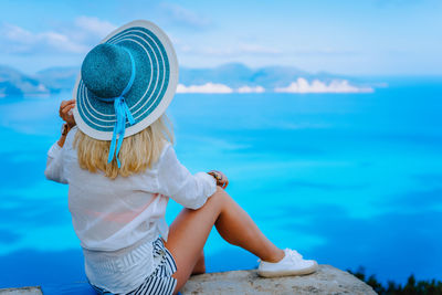 Woman looking at sea against sky