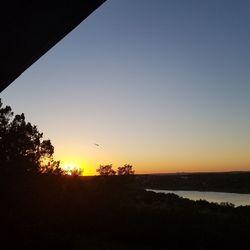 Scenic view of silhouette trees against sky during sunset