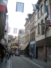 People on street amidst buildings in city