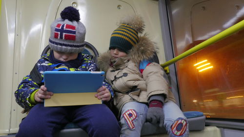 Portrait of boy using digital tablet in car