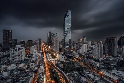 Aerial view of city against cloudy sky