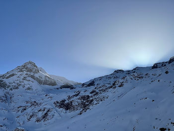 Scenic view of snowcapped mountains against clear sky