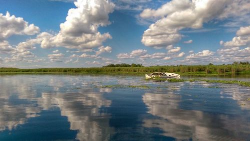 Abandoned boat in lake monroe against sky