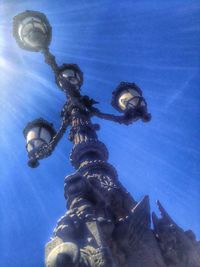 Low angle view of lamp post against blue sky