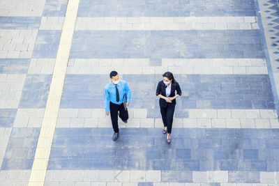 High angle view of people walking in city