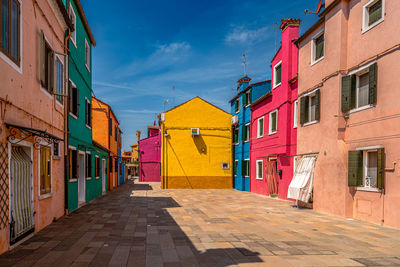 Street amidst buildings against sky