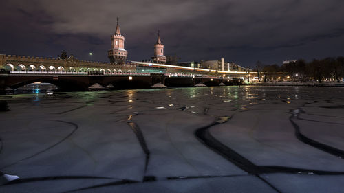 Oberbaum bridge over frozen river against sky