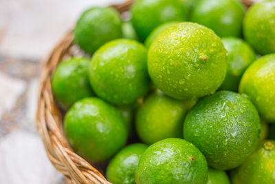 Close-up of green fruits in basket