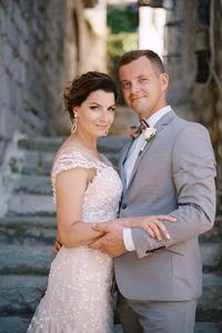 Portrait of smiling couple standing outdoors