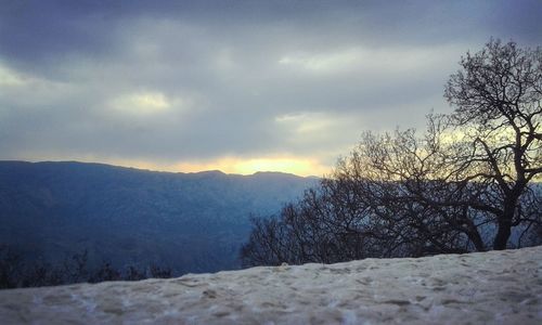 Scenic view of mountains against sky during winter