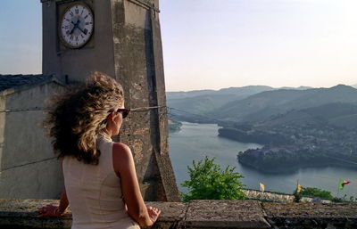 Woman looking at view against mountain range