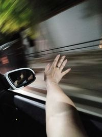 Midsection of person seen through car window