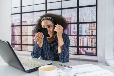 Businesswoman talking on phone in office