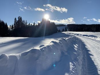 Scenic view of snow covered field against sky