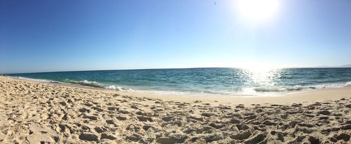 Scenic view of beach against clear sky