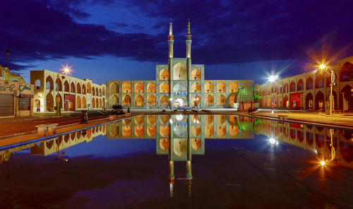 Reflection of illuminated buildings in water at night