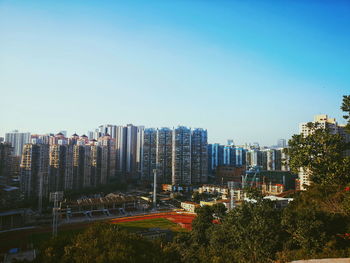 Modern buildings against clear blue sky