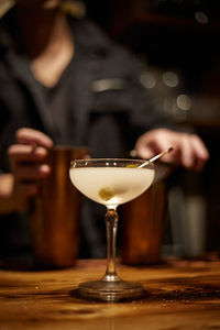 Midsection of woman holding wineglass