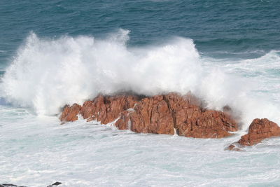 Waves breaking against sea