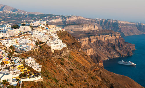 Cityscape of fira town with white houses and the caldera in santorini, greece. 