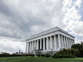 Low angle view of lincoln memorial against cloudy sky