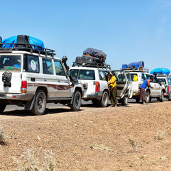 Cars on road against clear blue sky