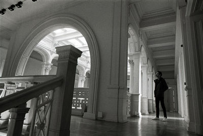 Rear view of woman walking in corridor of building