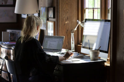 Woman using computer at home