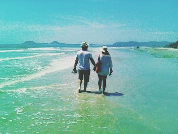 Rear view of women on beach