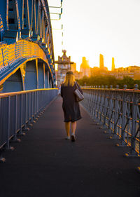 Woman walking on footbridge