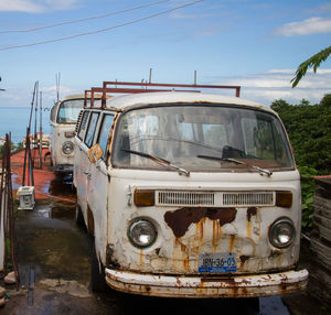 Abandoned car against sky